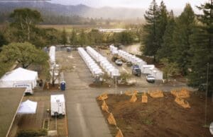 An aerial view of several tents in a parking lot.