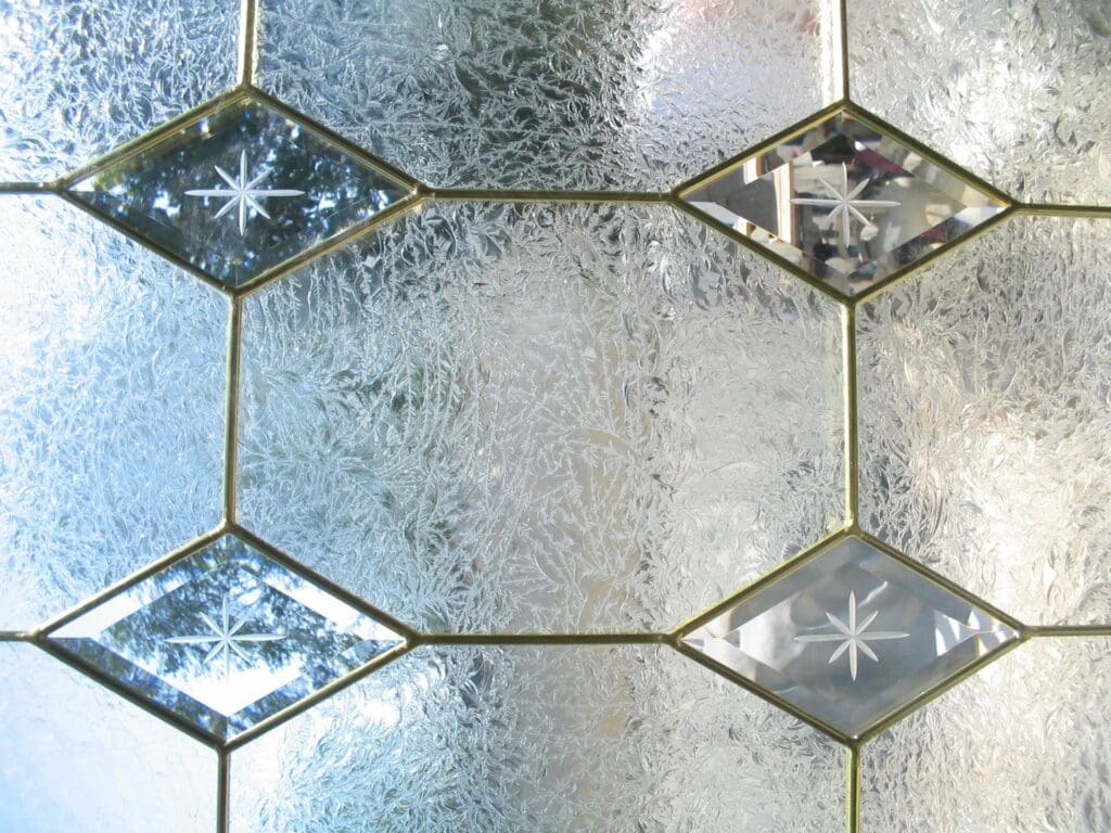 A close up of a glass window with diamonds on it.