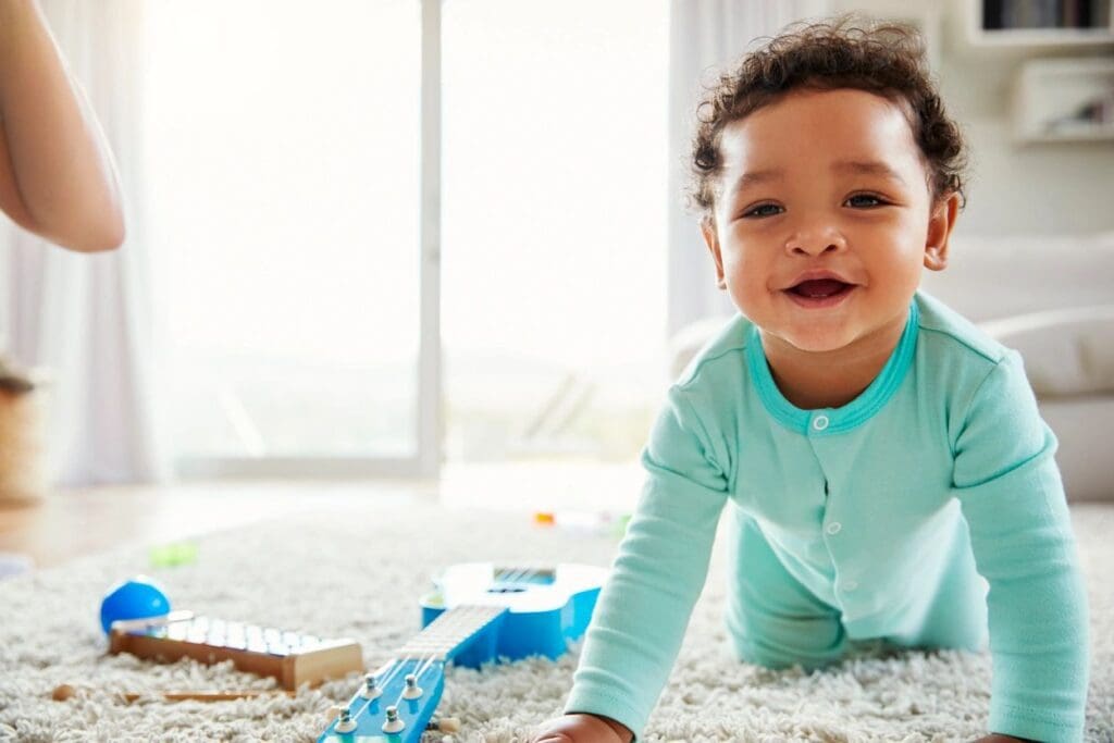 A baby is playing with toys in a living room.
