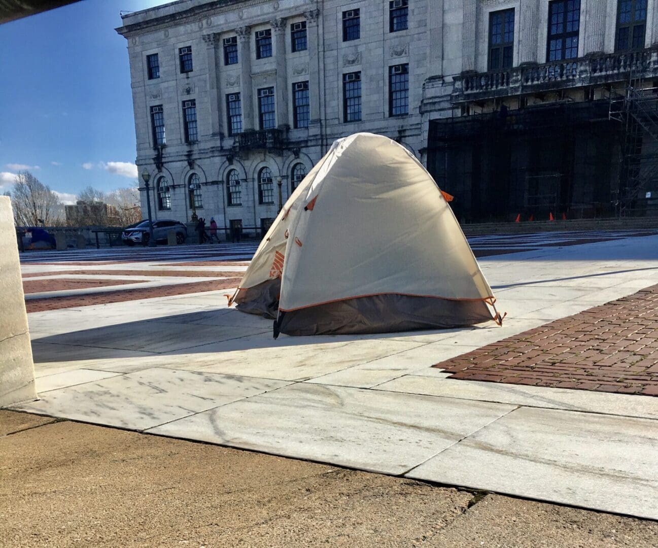 A tent is set up in front of a building.