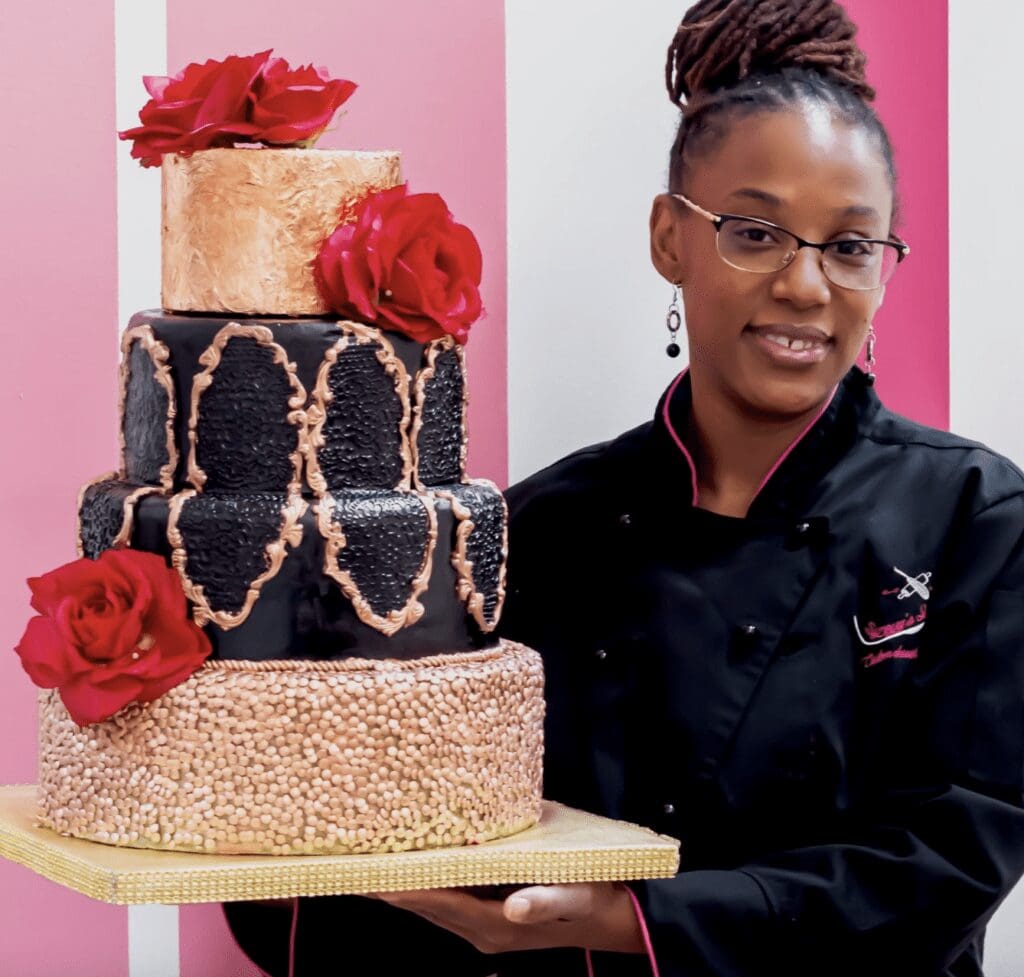 A woman holding a three tier cake.