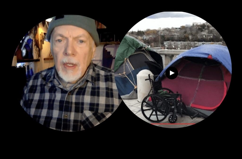 A man in a wheelchair in front of a tent.