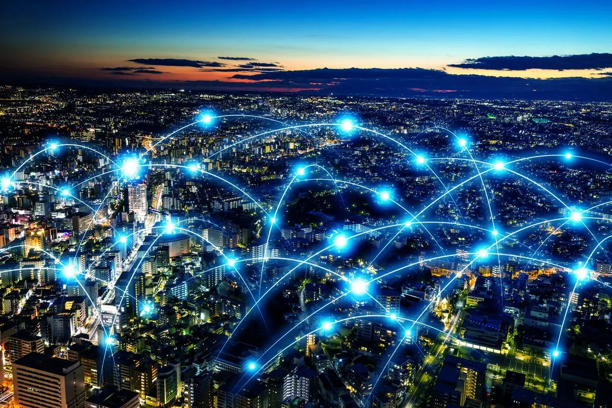 An image of a city at night with a network of connections.
