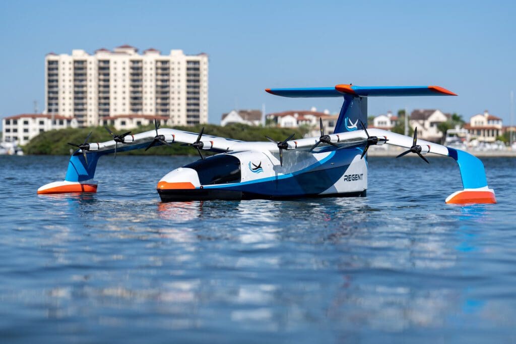 A toy airplane floating in the water with buildings in the background.
