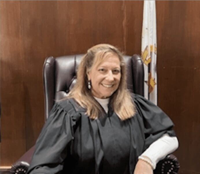 A woman sitting in a judge's chair.