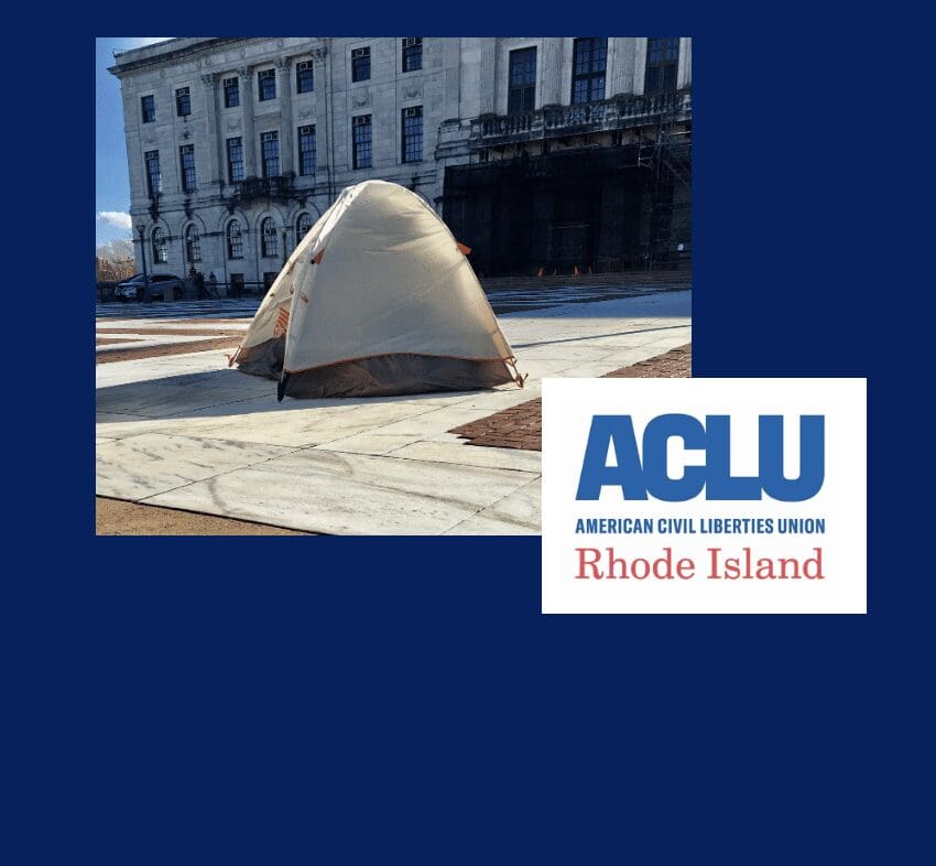 A tent in front of a building with the words aclu rhode island.