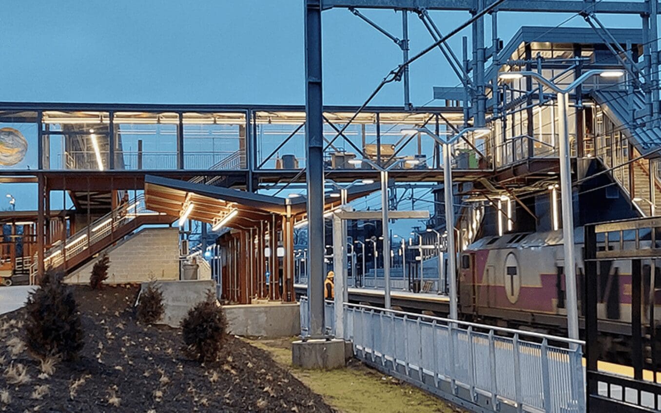 A train pulls into a station at dusk.