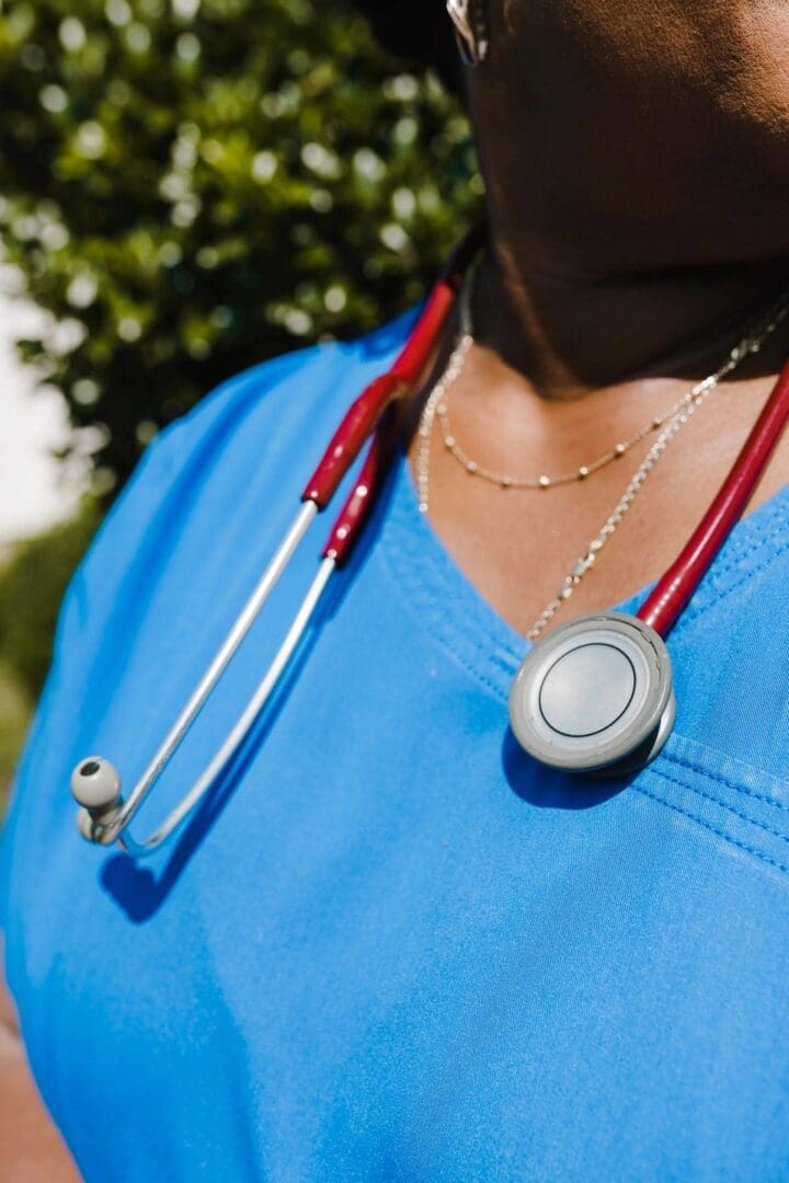 A nurse wearing a blue scrub top and stethoscope.
