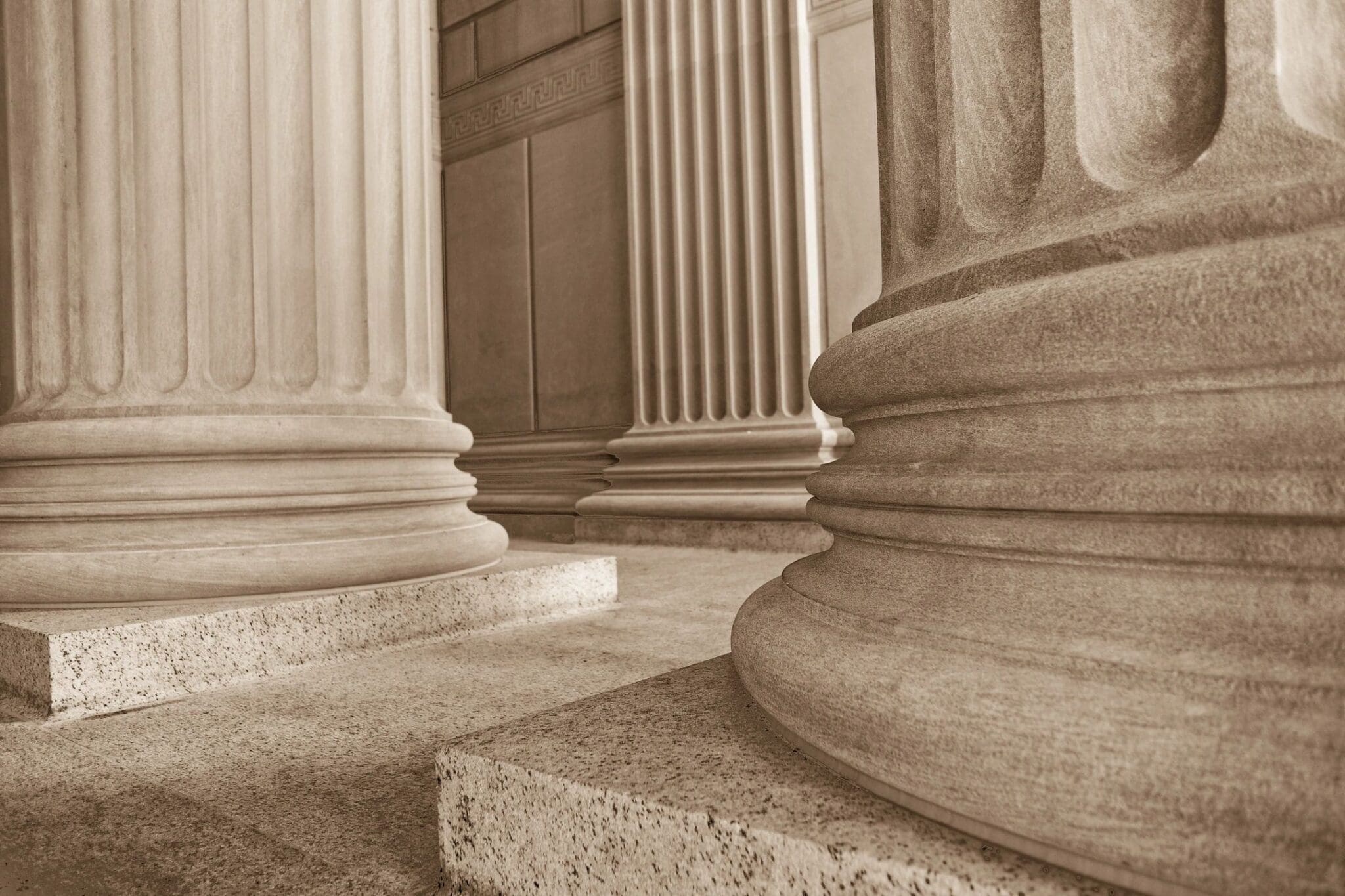 A photo of a row of columns in sepia.