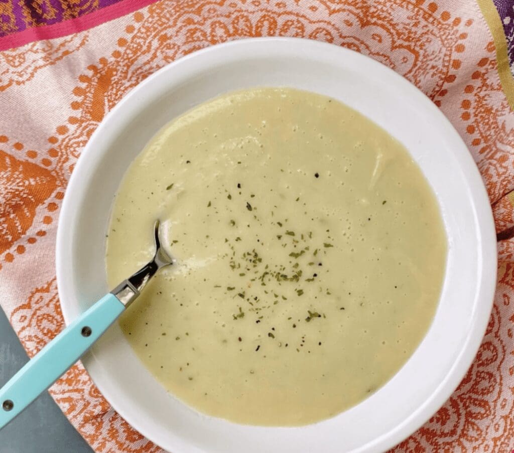 A bowl of soup with a spoon in it.
