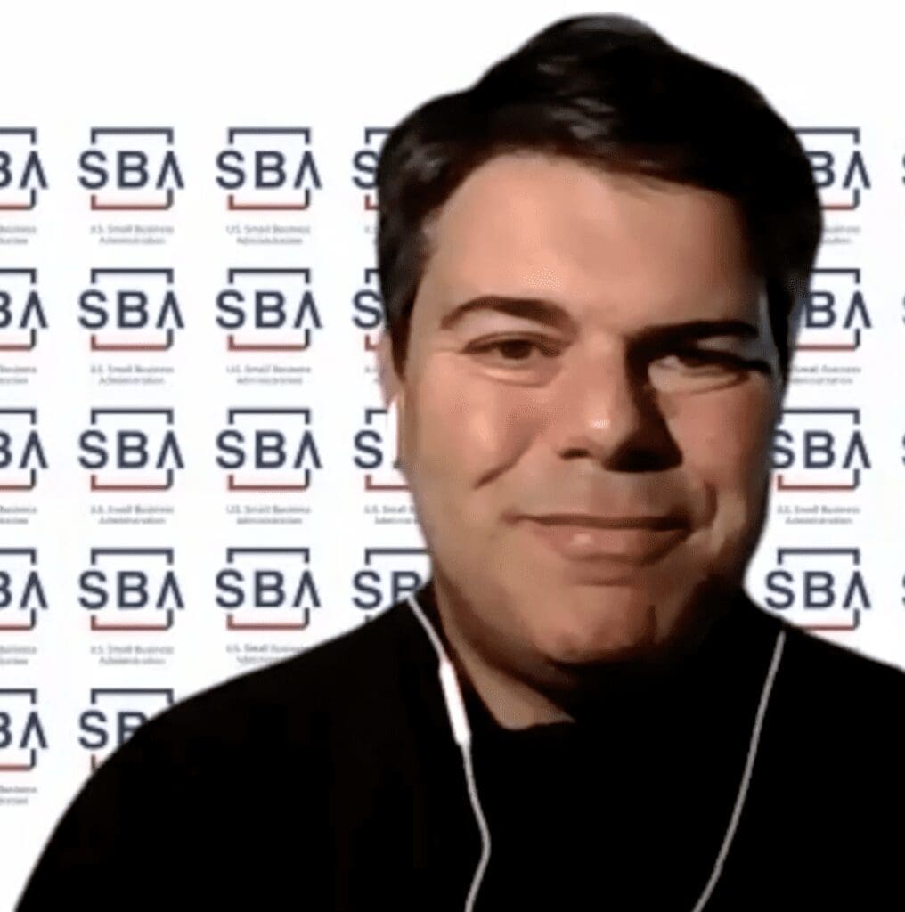 A man in front of a sba logo.