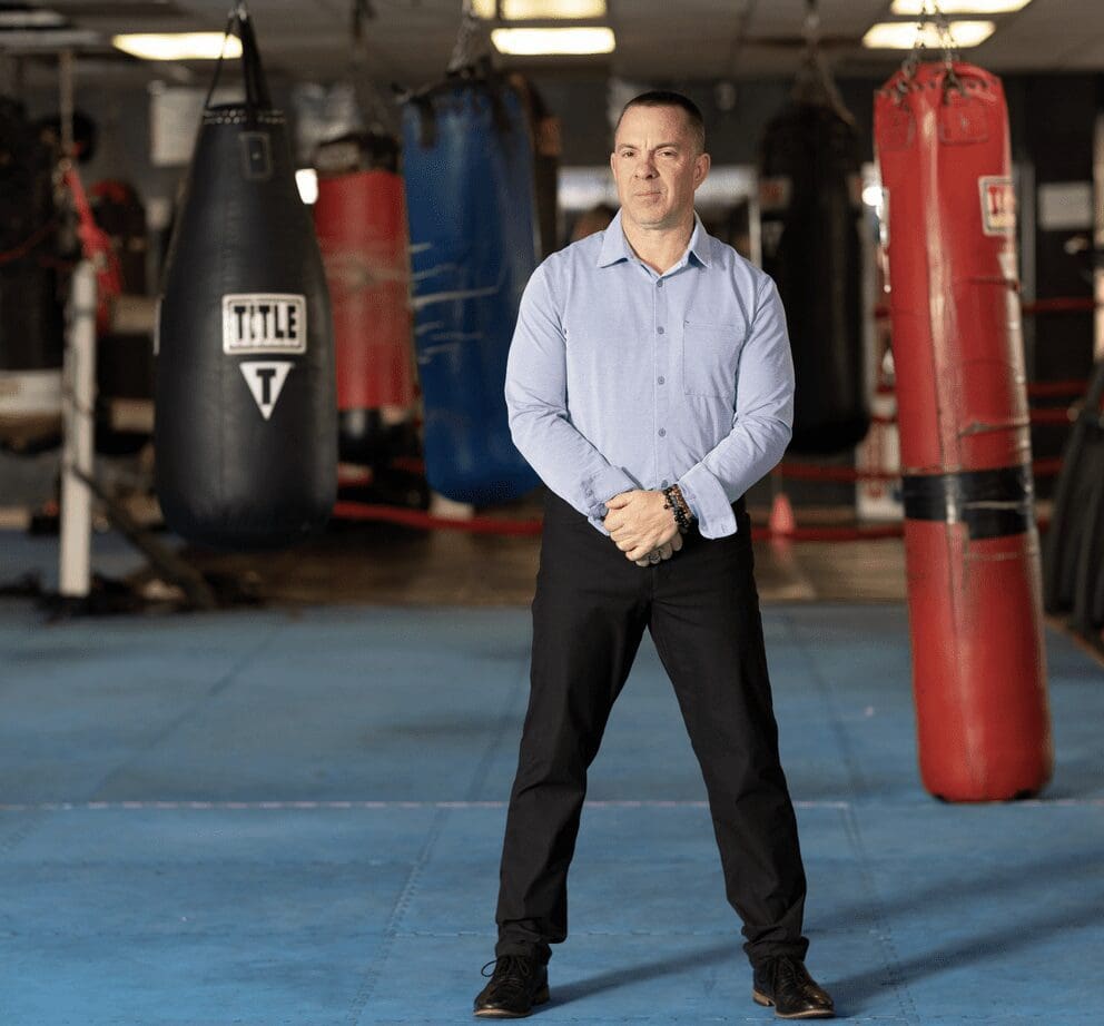 A man standing in front of a boxing ring.