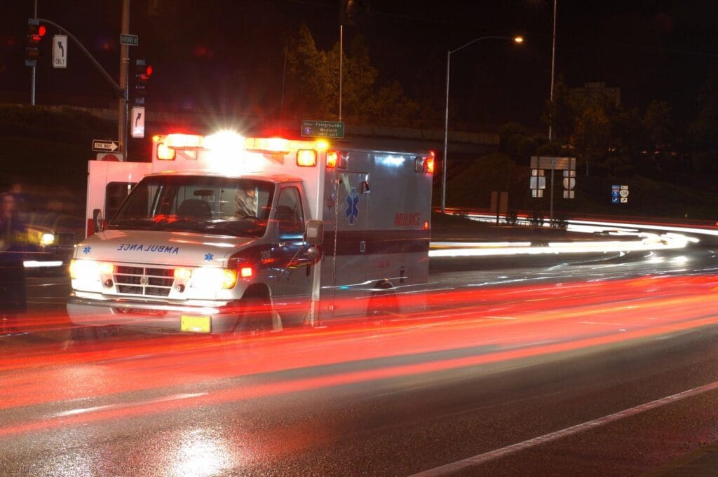 An ambulance driving down the road.
