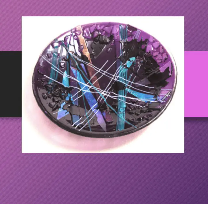 A purple and blue plate displayed against a vibrant purple background, showcasing artistic beauty.