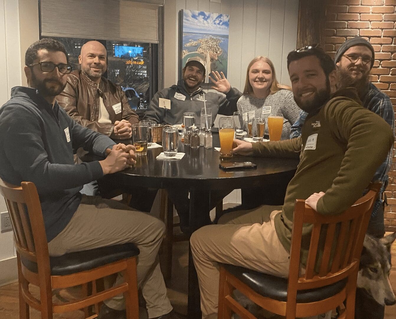 A group of people sitting around a table.