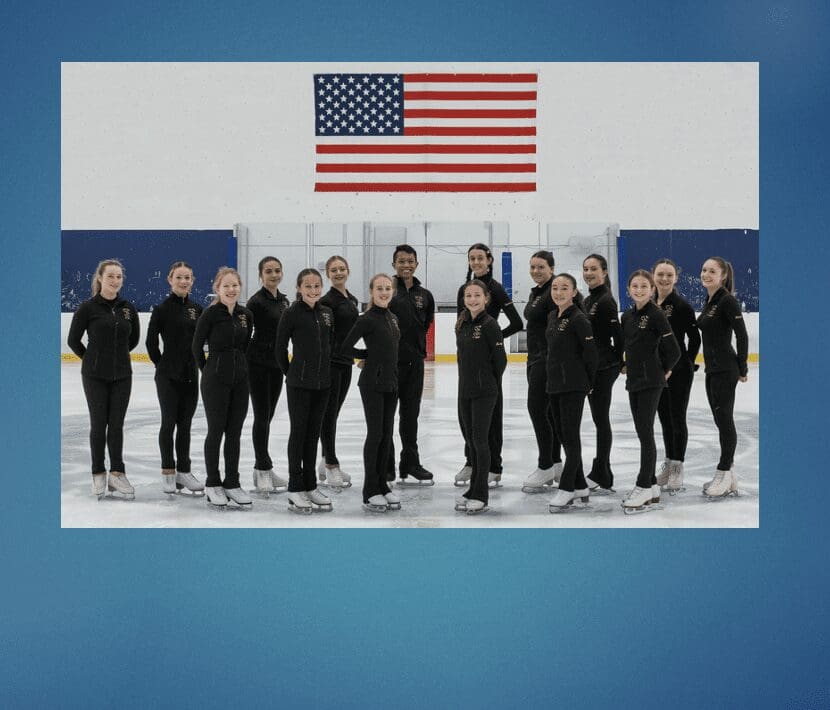 A group of ice skaters posing in front of an american flag.
