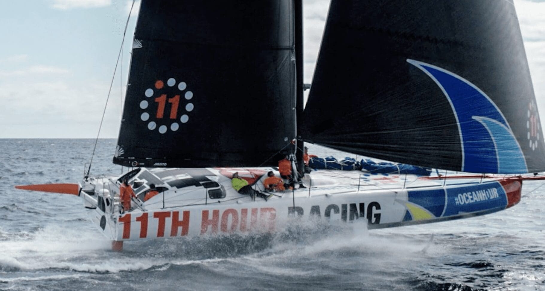 A sailboat participating in The Ocean Race with its sails up.