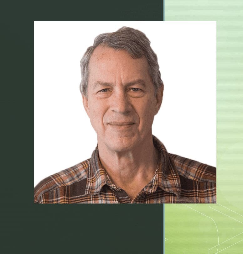 A man in a plaid shirt with a green background.
