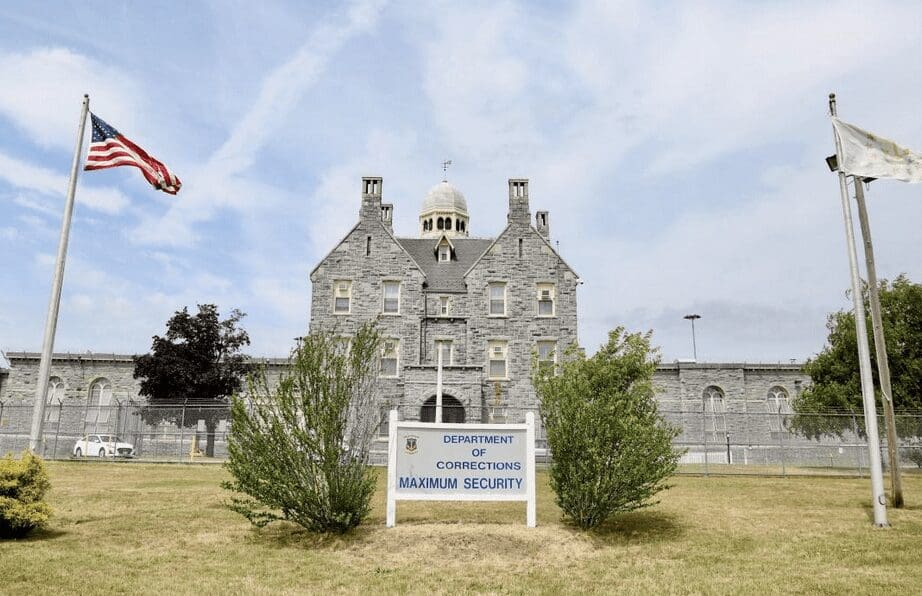 A large stone building with flags in front of it, serving as a symbol of national heritage and corrections.
