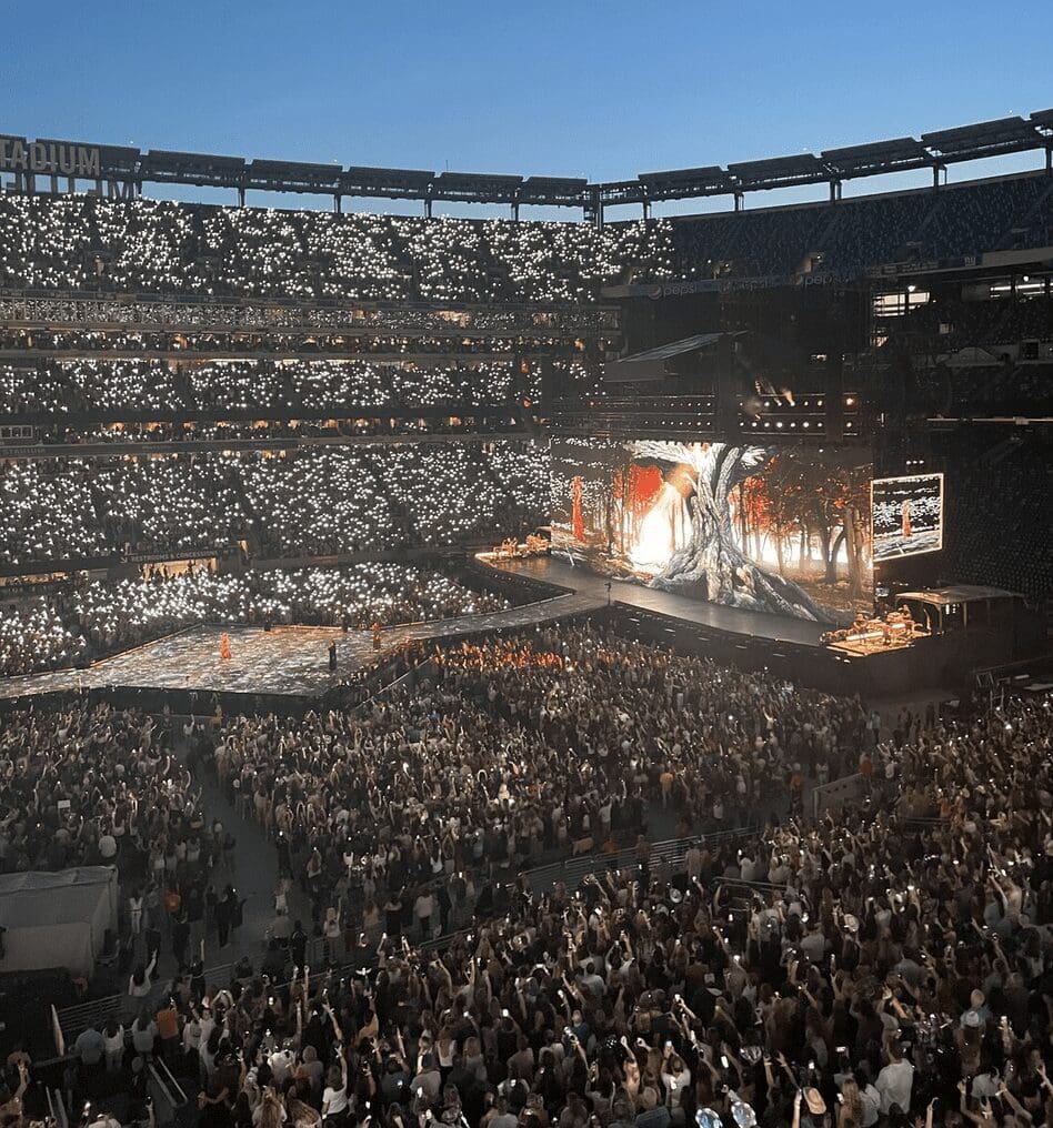 A stadium full of people watching a Taylor Swift concert.