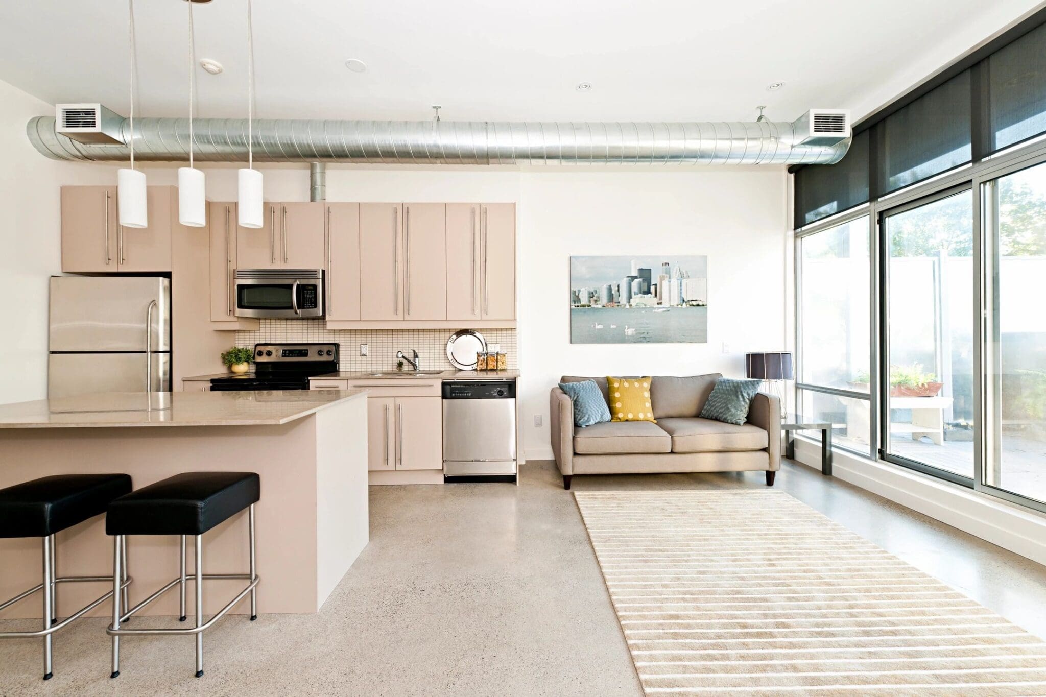 A kitchen and living room in a modern apartment.