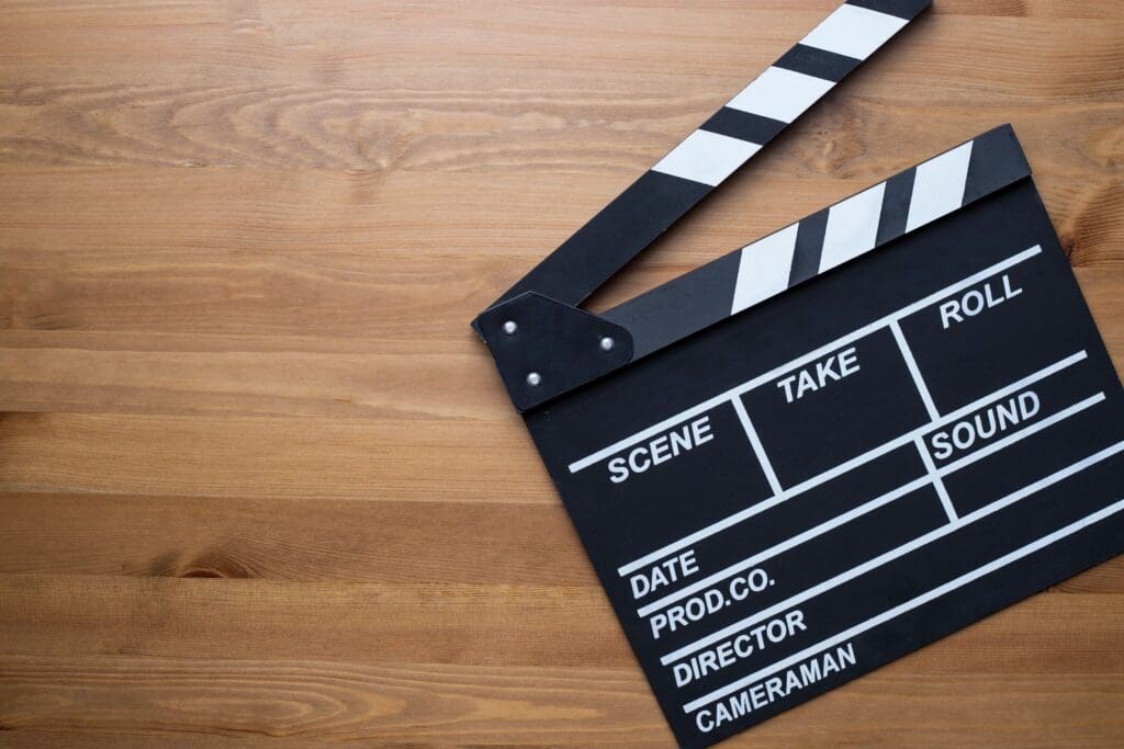 A movie clapper on a wooden table.