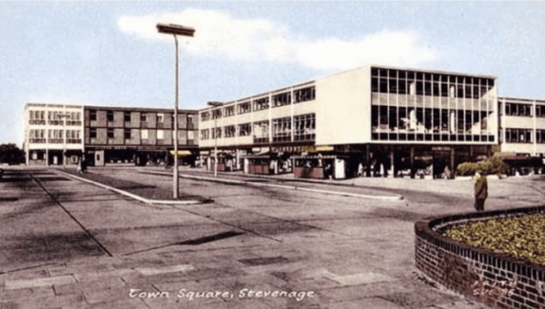 An ancient postcard featuring the architectural design of a shopping center.