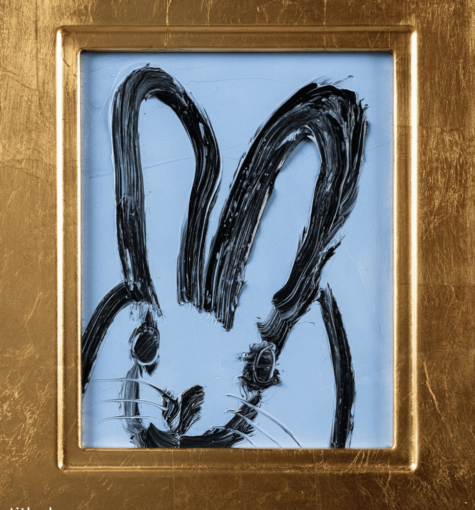 A black and blue bunny in a gold frame, created by Hunt Slonem.