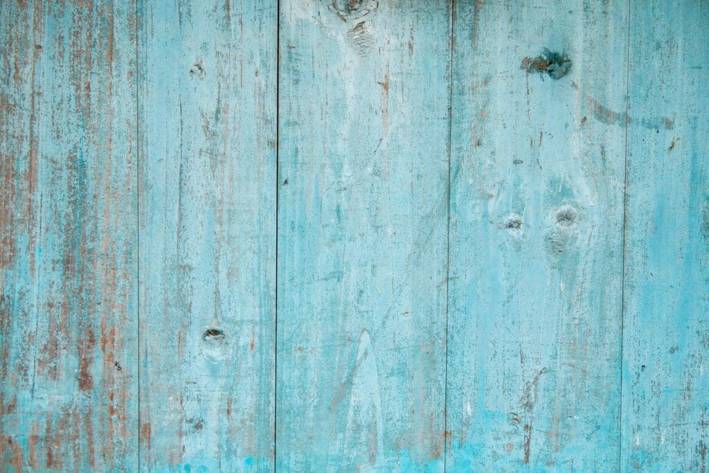 A close up of a blue painted wooden wall.