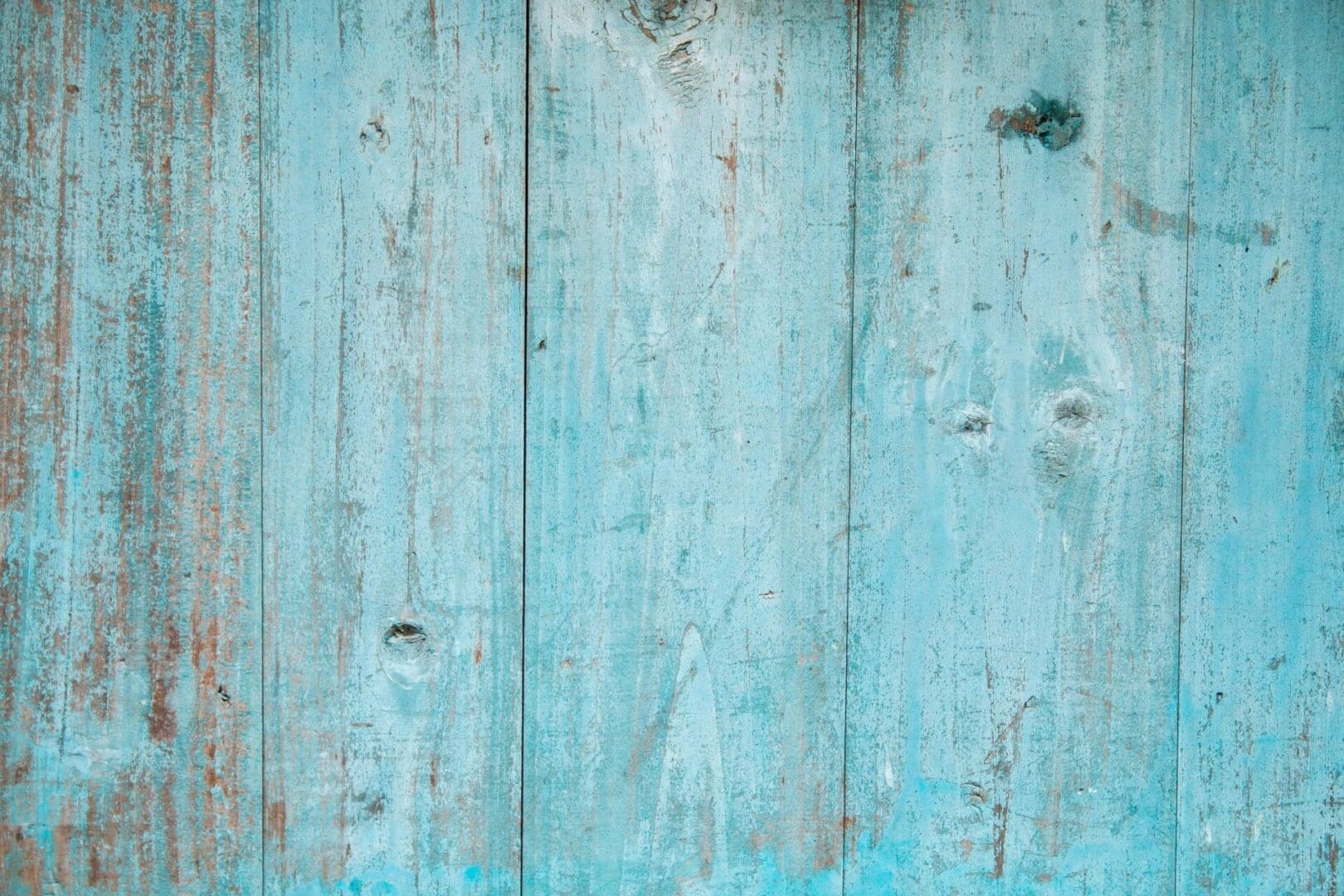 A close up of a blue painted wooden wall.