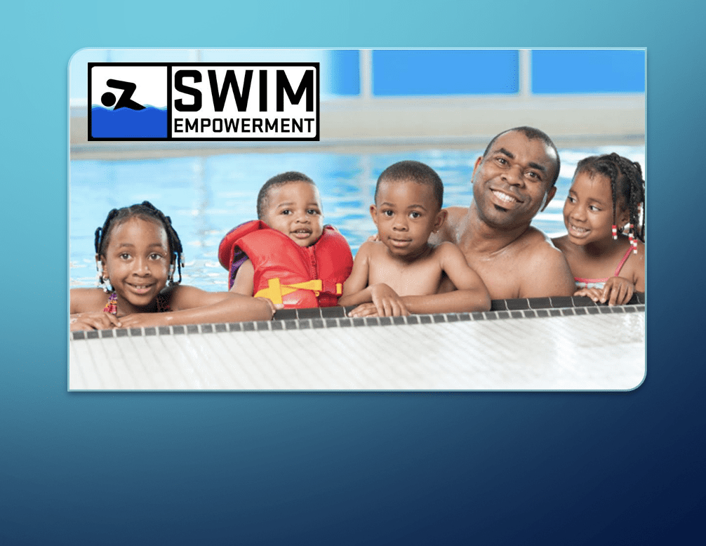 A picture of a family learning to swim in a swimming pool.