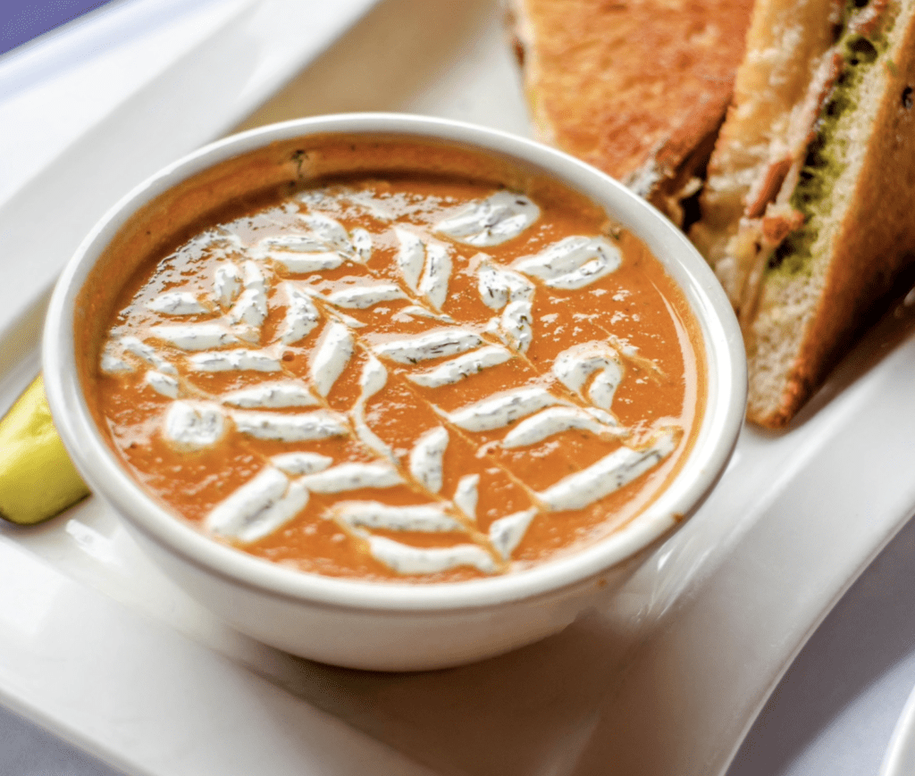         A bowl of soup and a sandwich on a plate, perfect for quick and easy recipes.