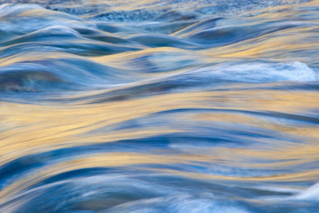 A close up of a river with blue and yellow water.