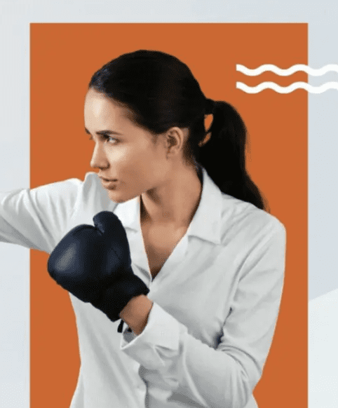 A woman in a white shirt is holding a boxing glove for exercise.