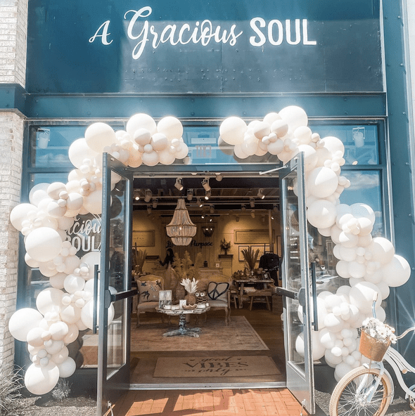 A gracieux soul store featuring white balloons and a networking sign.