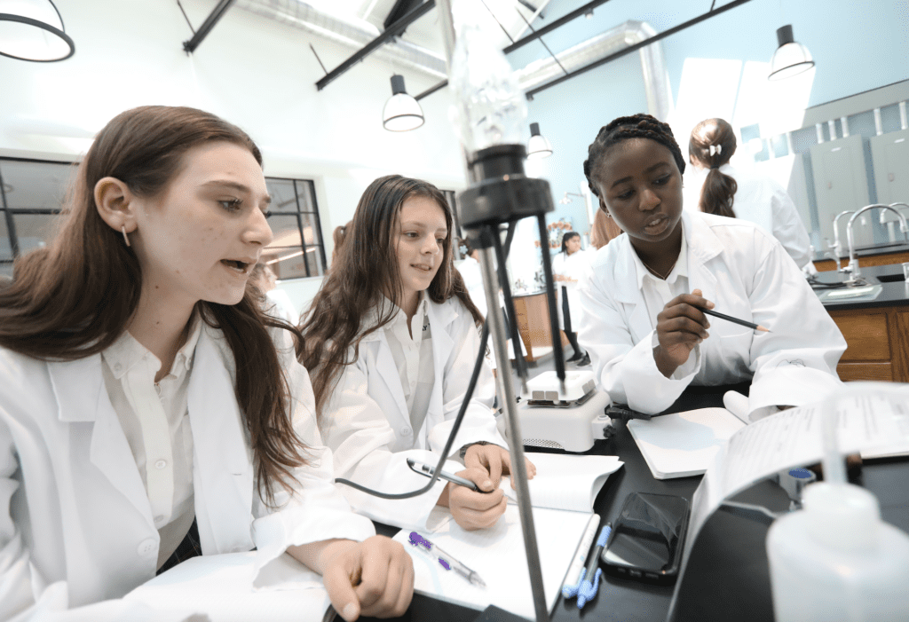 A group of women in lab coats from Bay View working together.