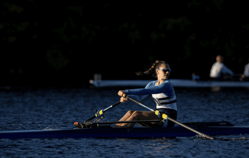 A woman is engaging in rowing.