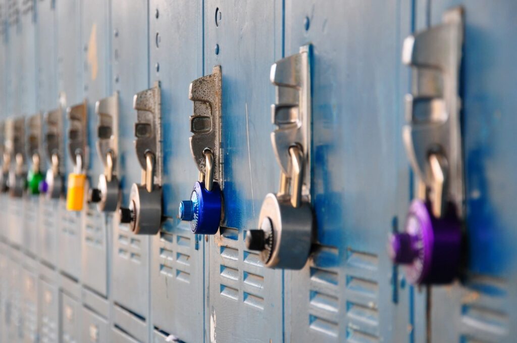A row of lockers with different colored locks.