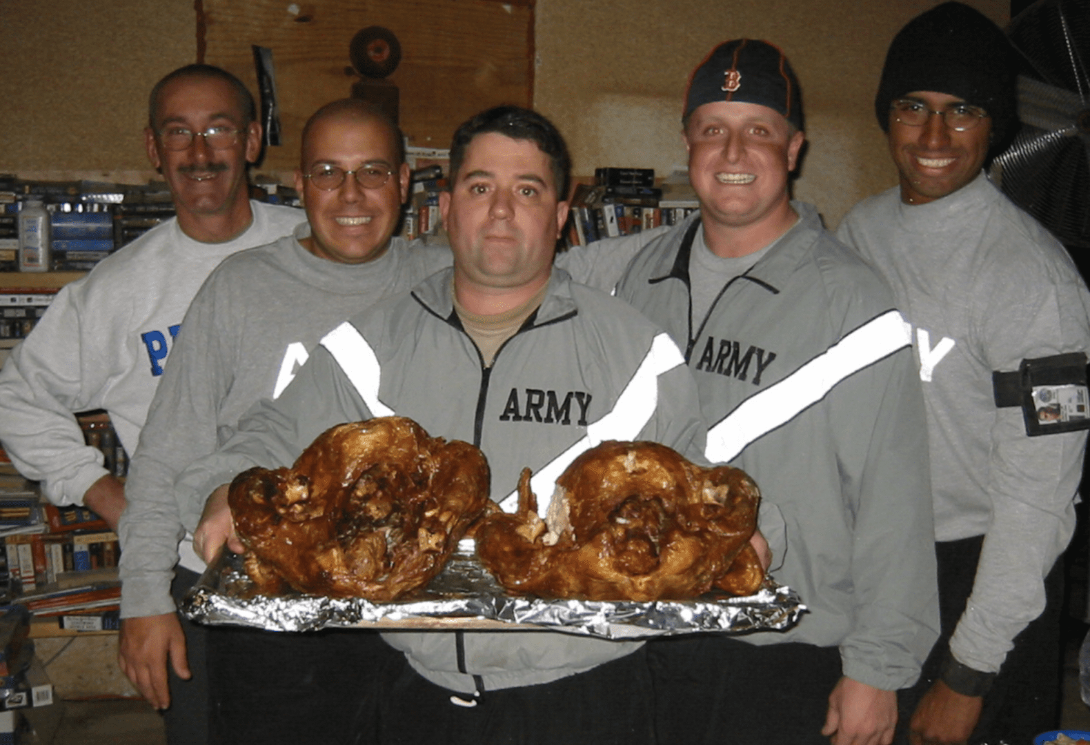 A group of veterans posing with turkeys.