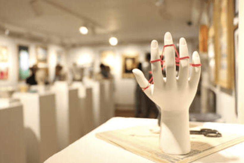 A mannequin hand on display in an art gallery, showcasing the intricate craftsmanship and attention to detail.