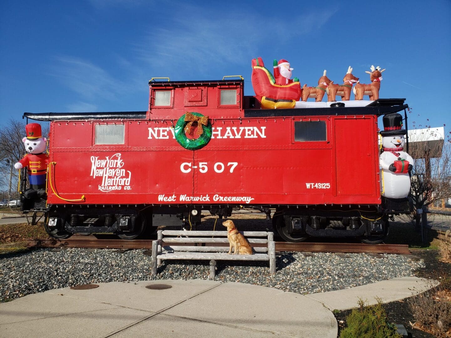 A red caboose with santa claus on it.