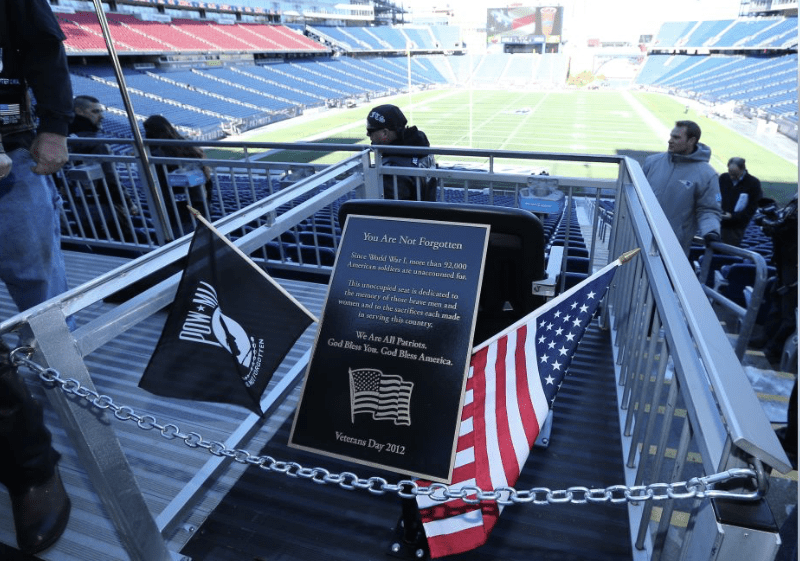 A patriotic plaque at a football stadium, featuring the American flag, commemorating the Army-Navy game.