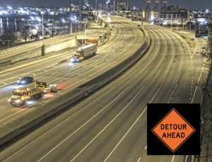 Detour ahead signs on Route 195 at night.