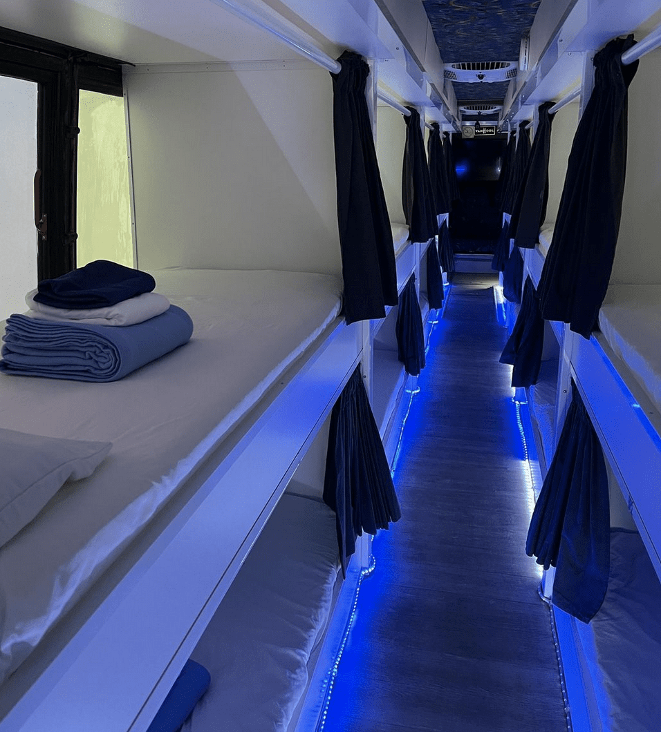A row of bunk beds in a room with blue lights, providing shelter for homeless individuals in Rhode Island (RI).