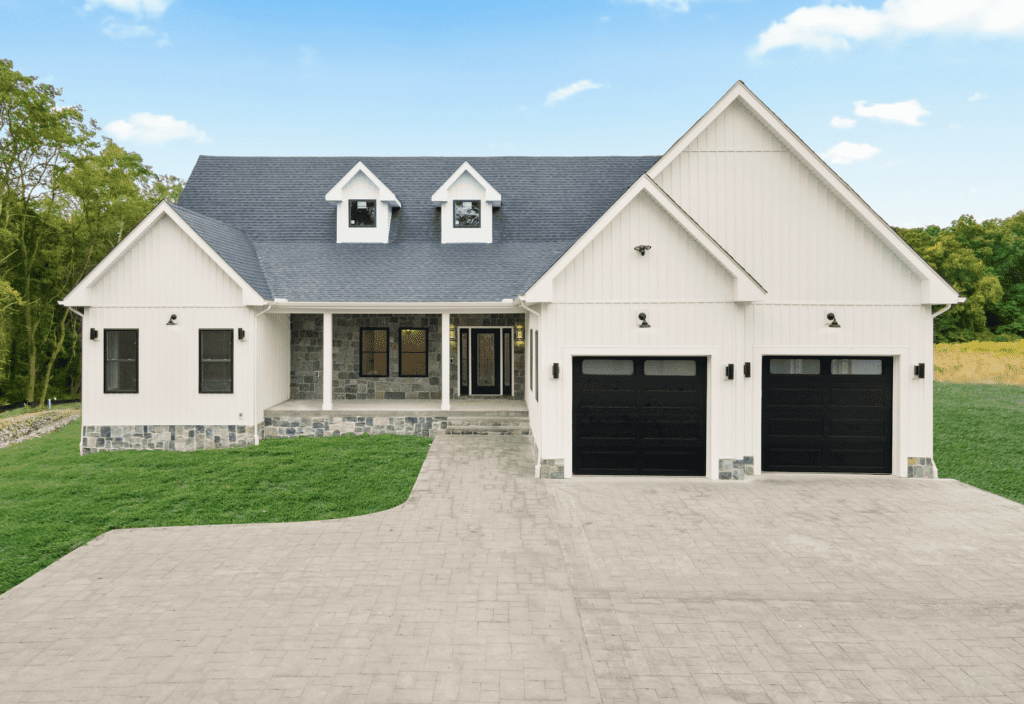 Johnston real estate: A rendering of a home with two garages and a driveway, showcasing stunning Johnston real estate options.