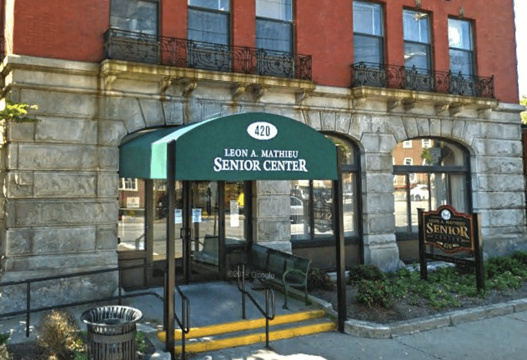 A building with a green awning in front of it.