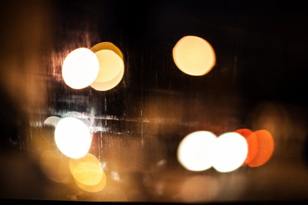 A blurry image of street lights at night.