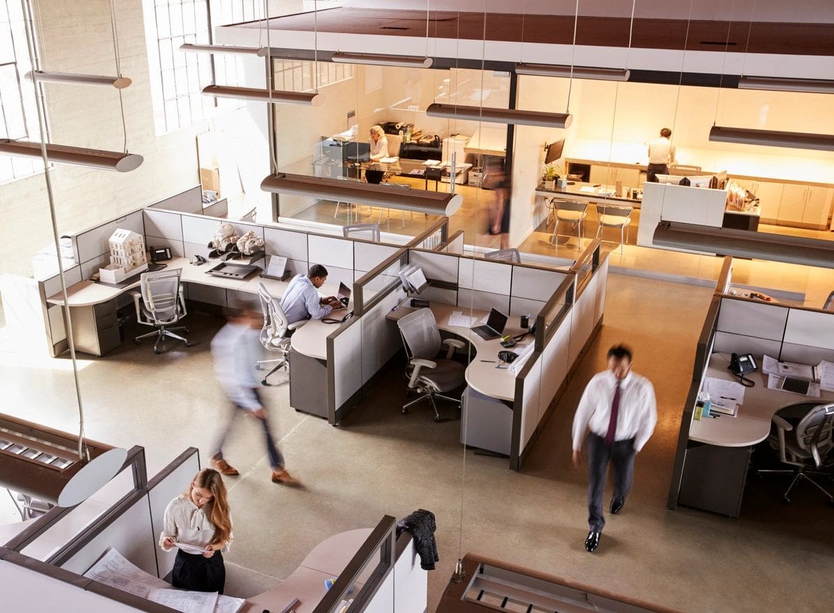 A view of a large office with people walking around.