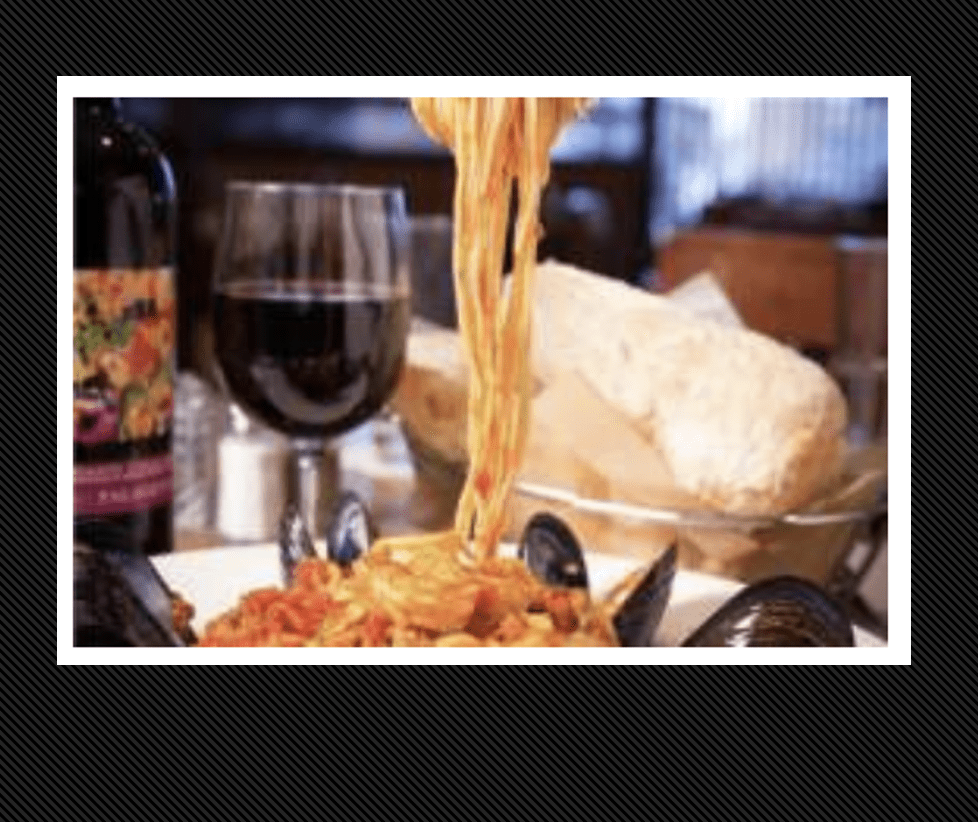 A plate of spaghetti with a glass of wine during Providence Restaurant Week.
