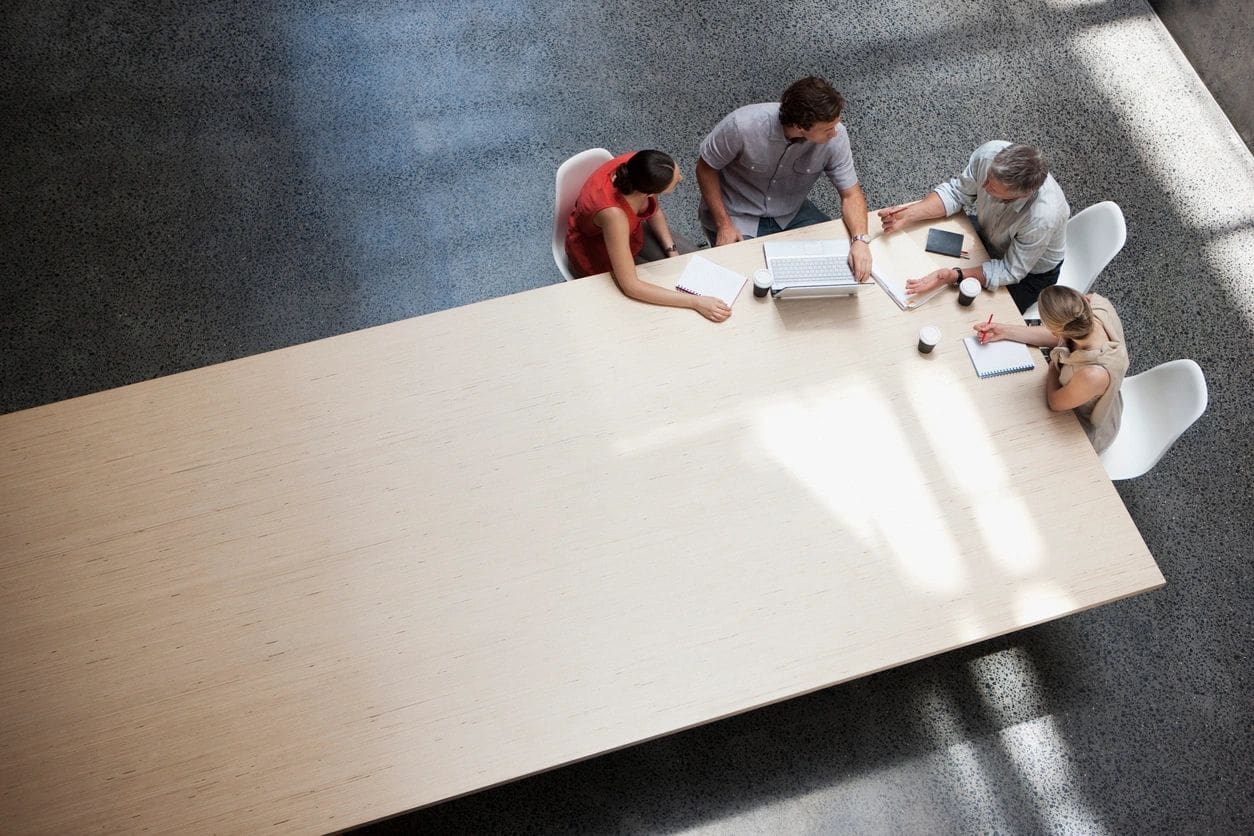 A group of people sitting around a conference table.